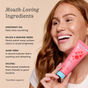 A smiling woman with long red hair holds a pink tube of COCOLAB Cocoshine Whitening Toothpaste. Left text lists gentle ingredients: coconut oil, silica & baking soda, aloe vera, and xylitol—ideal for naturally strengthened enamel.