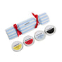 The Holiday Bonbon by Everist features a blue and white striped cracker with red ribbons, paired with four travel minis—shampoo, conditioner, and body care—in yellow, red, blue, and black tins.