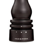 Close-up of a dark wooden Cole & Mason Wood Salt Grinder, showing dot grind select markings. The ceramic grinding mechanism ensures durability, with the brand name in white at the base.