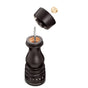 A black Cole & Mason Wood Pepper Grinder is shown disassembled, with its top, adjustable grind select knob, and main body aligned vertically to reveal the Precision+ carbon steel grinding mechanism.