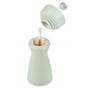 The Cole & Mason 2-in-1 Kenton Salt & Pepper Mill features a ceramic grinder and a smooth, curved design. With its top removed to reveal the mechanism, it stands out as an eye-catching table accent among other mills.