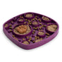 The West Paw Seaflex Bubbles Feast Mat is a purple all-in-one slow feeder and lick mat for pets, with compartments for wet and dry food, designed to encourage slower eating and enrichment.