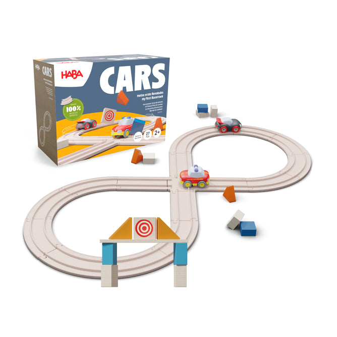 The HABA My First Racetrack is a figure-eight track for ages 2+, made from 100% recycled materials. It features colorful toy cars, geometric shapes, a gate, and comes in a box labeled HABA CARS for creative play.