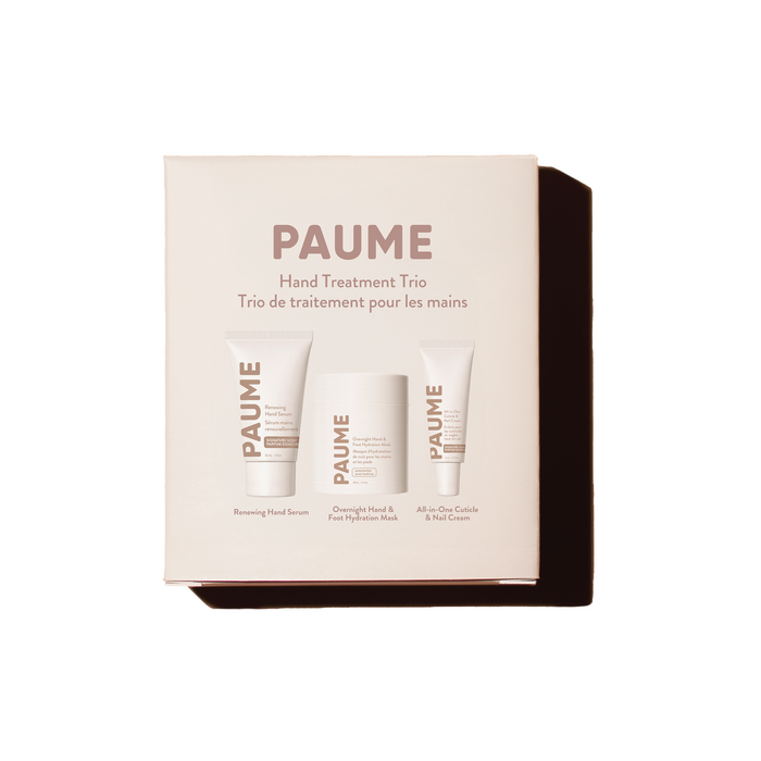 A box labeled Hand Treatment Trio Gift Set by PAUME contains Renewing Hand Serum, Overnight Hydration Mask, and All-in-One Cuticle & Nail Cream for hydrated hands and complete nail care.