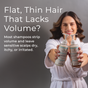 A smiling woman with wavy hair holds Tree To Tub’s Volumizing Caffeine & Biotin Shampoo and Conditioner for Fuller, Thicker Hair. Text reads: “Flat, thin hair? Many shampoos strip volume and leave your scalp dry or irritated.”.