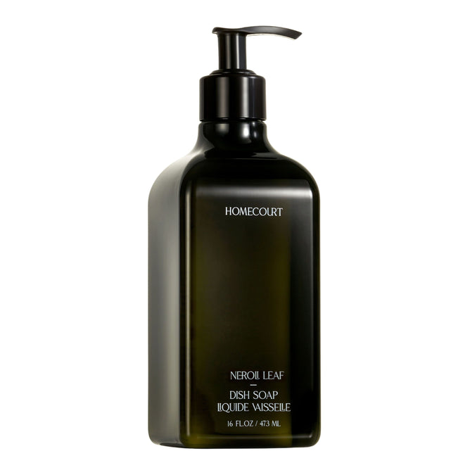A dark green bottle of Homecourt Dish Soap, 16 fl oz / 473 ml, with fragrance-forward scents and plant-derived surfactants, features a pump dispenser and is labeled Dish Soap Liquide Vaisselle against a white background.