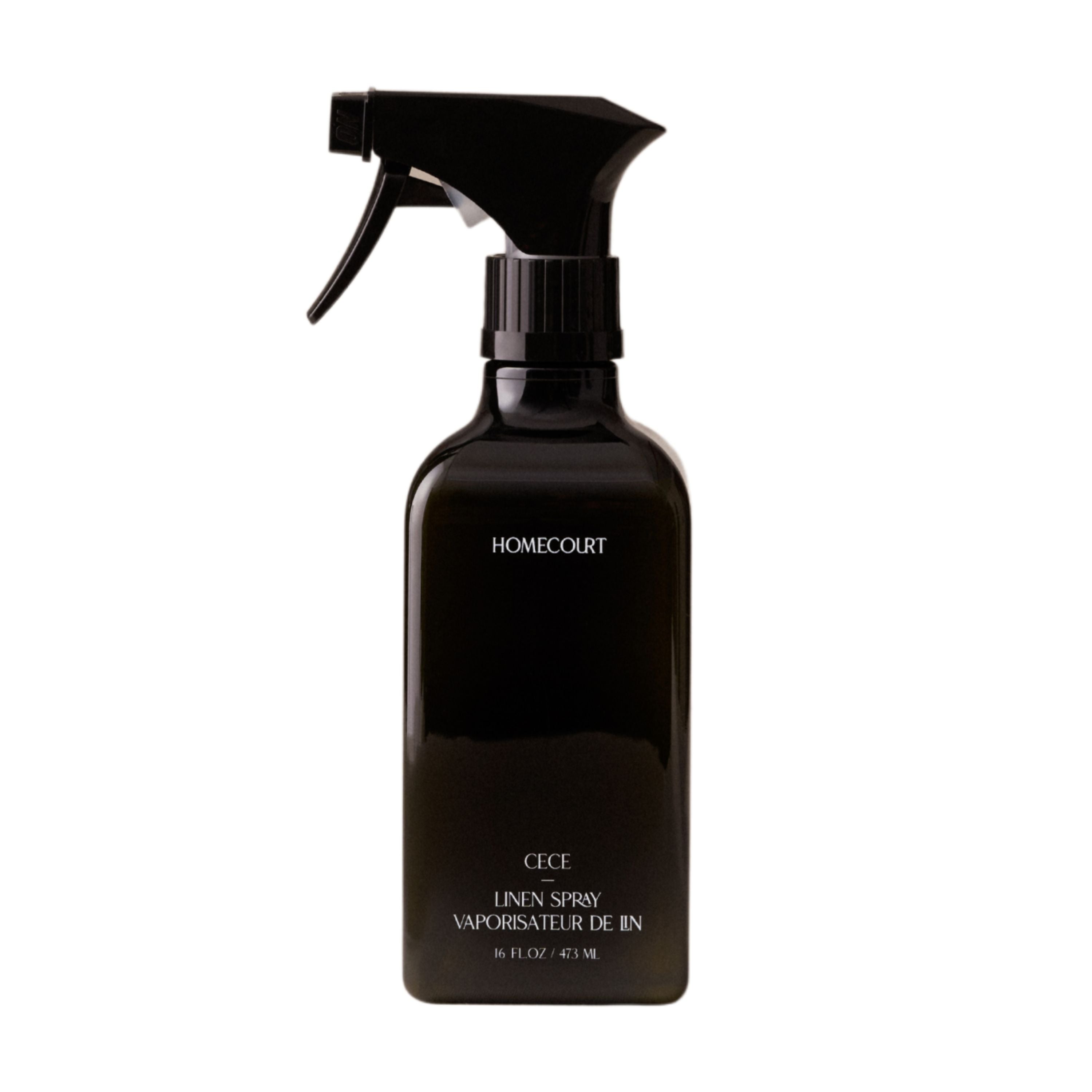 A black Homecourt spray bottle labeled Linen Spray features eco-friendly ingredients, a signature fragrance, and Vaporisateur de Lin, 16 fl oz / 473 mL in white text on the front.