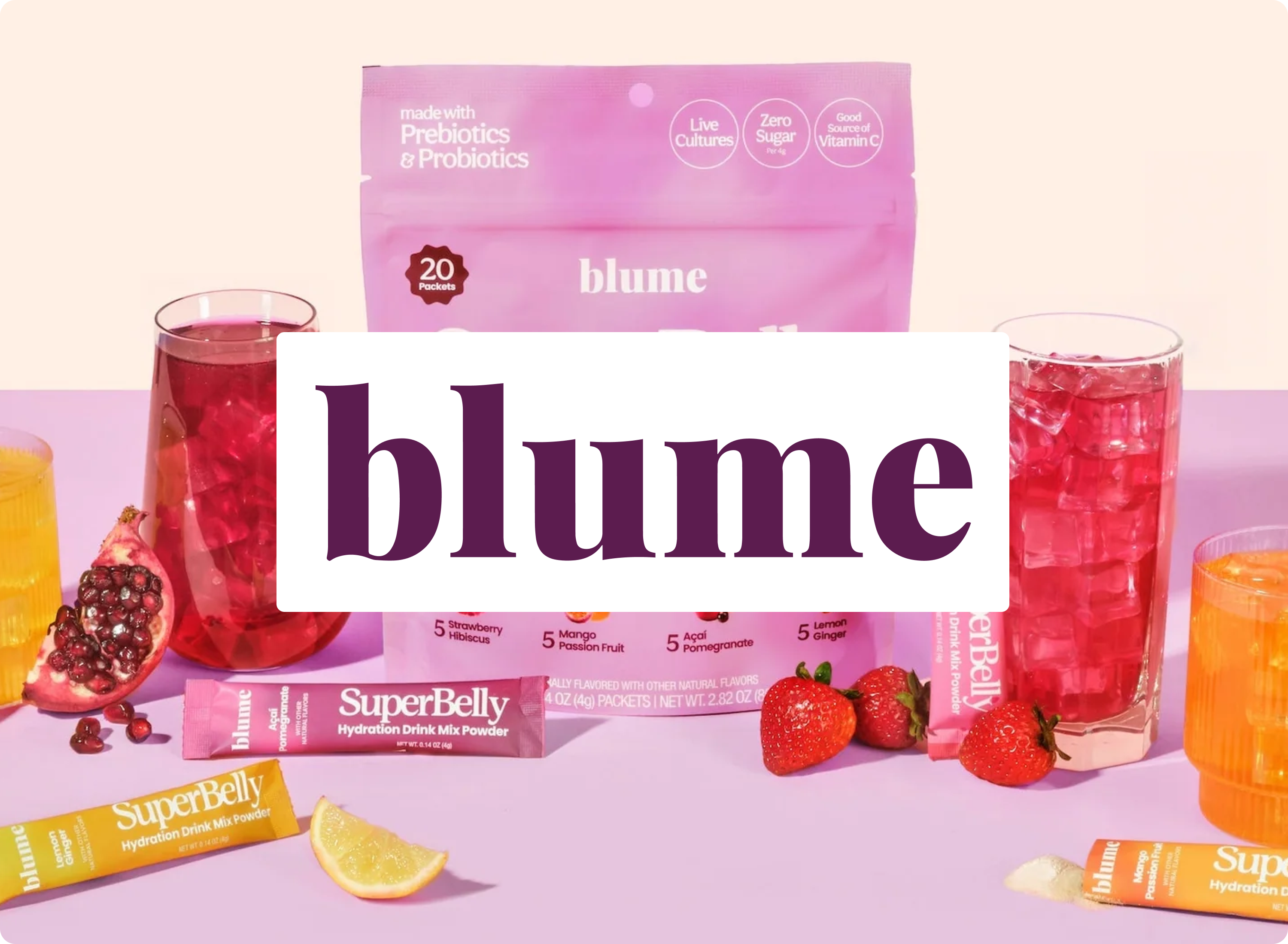Blume products including a pink package, glass of red juice, and strawberry on a light purple background.