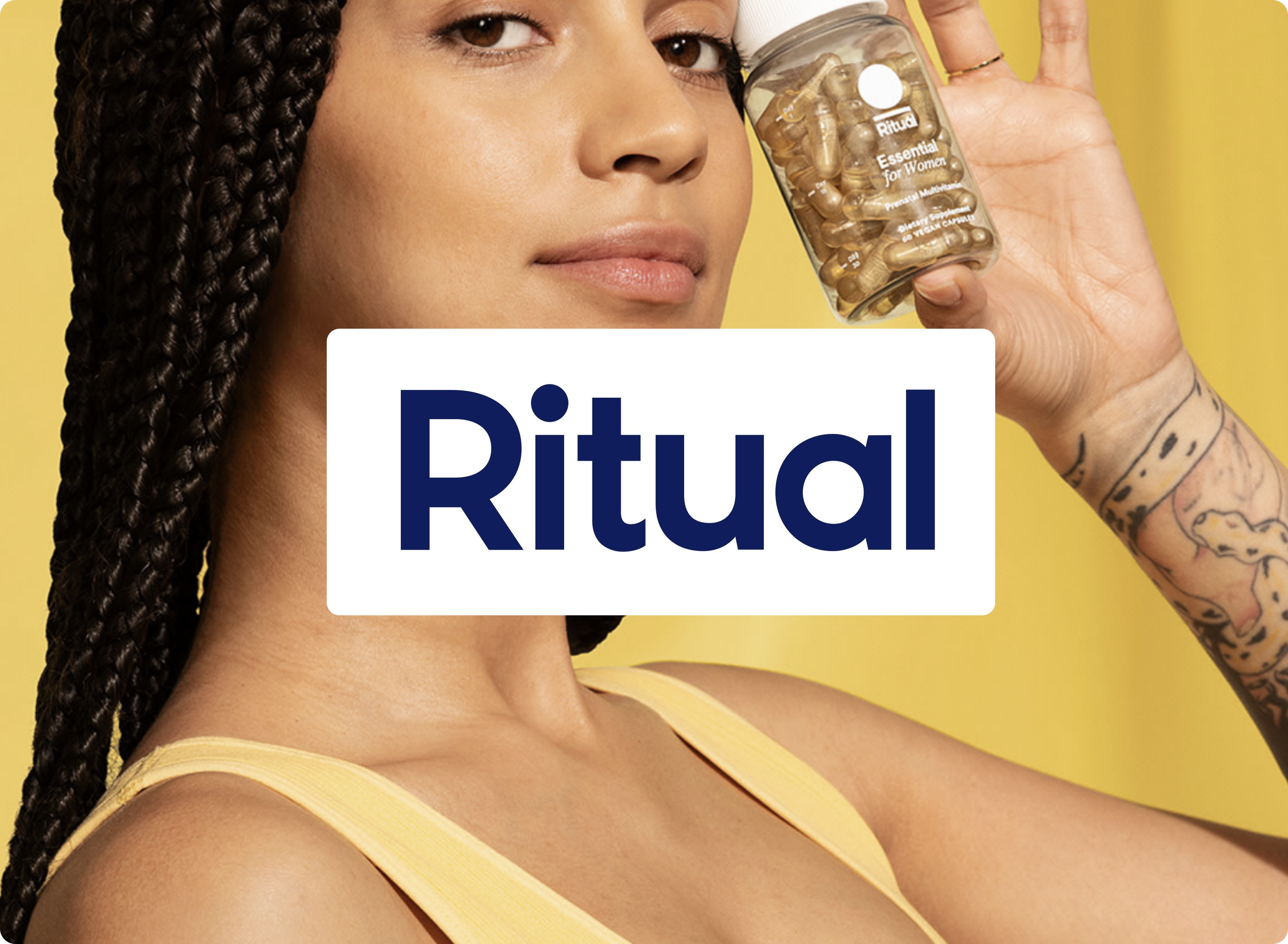 A person with long braids holds up a bottle of Ritual vitamins in front of a yellow background. The word Ritual in bold letters is centered over the image.
