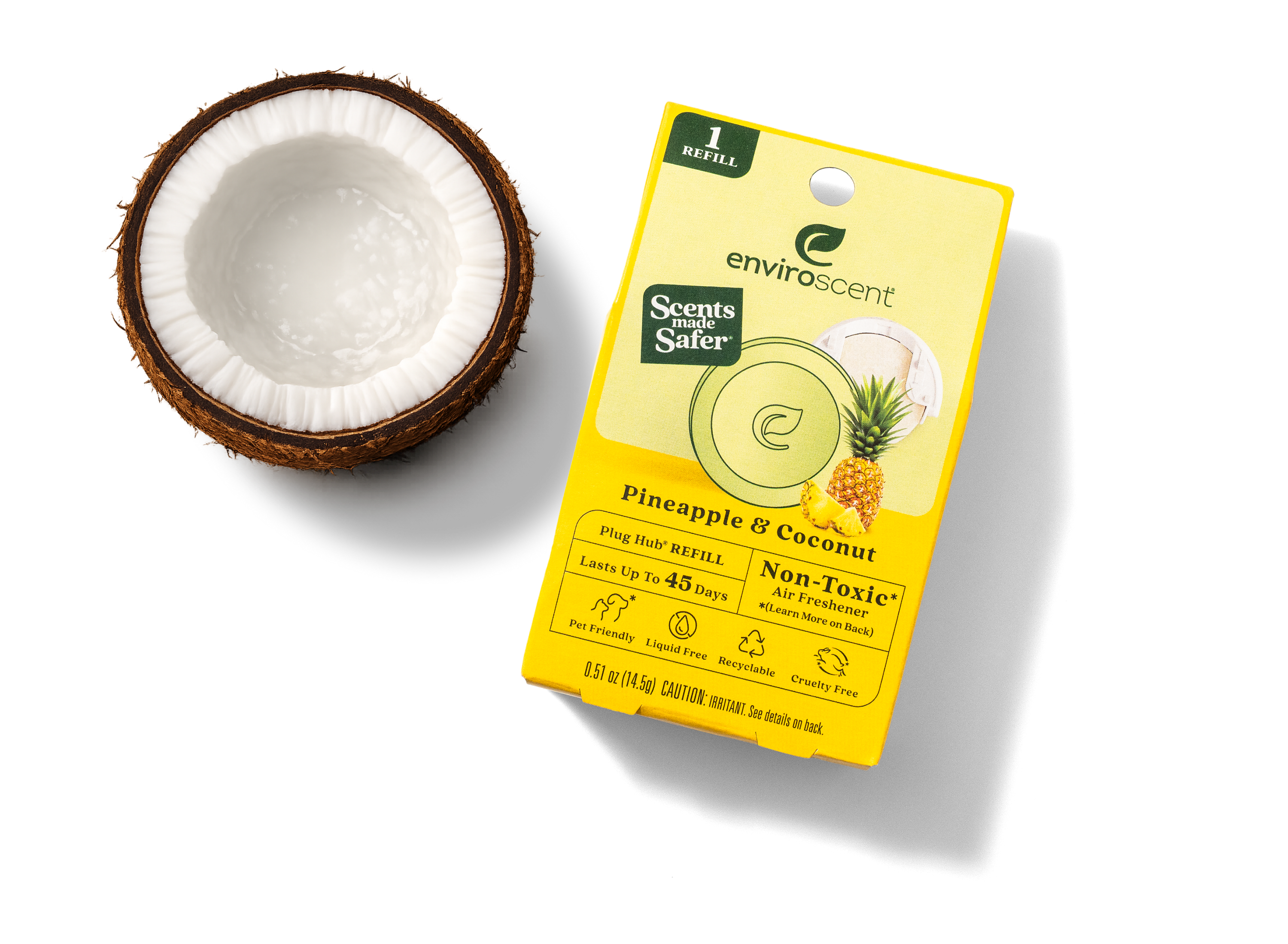 Seventh Generation pineapple and coconut air freshener next to a split coconut on a white background