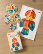 A HABA 2-in-1 Wooden Puzzle - Parrot, 4+ Years, shown as a wooden parrot-shaped puzzle with inset pieces, a matching poster of the assembled parrot, and the puzzle box on a wooden surface.