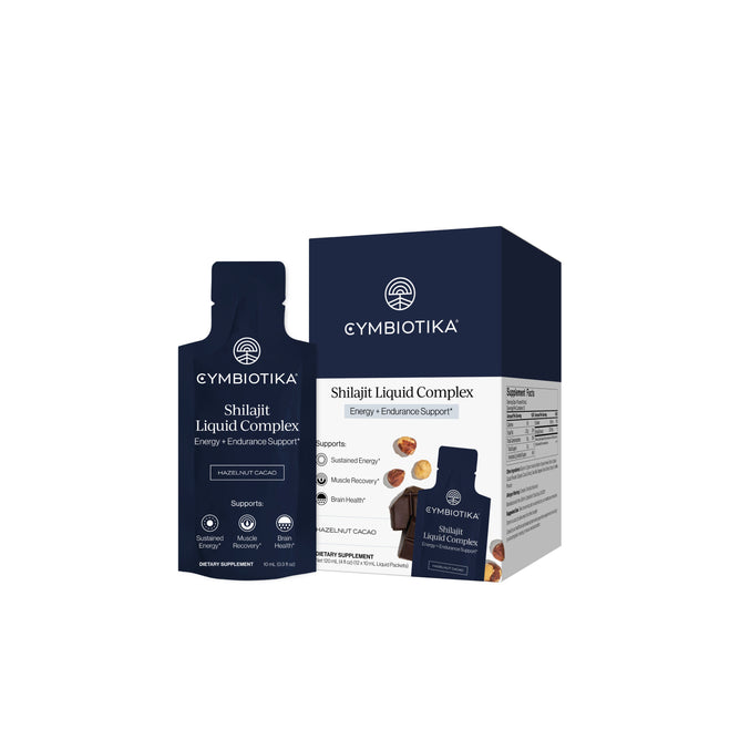 A packet and box of Cymbiotika Shilajit Liquid Complex Packets - Energy + Endurance Support, featuring dark blue packaging with white text, images of cocoa and shilajit resin, and a highlight on potent fulvic minerals for energy, endurance support, and cognitive function.