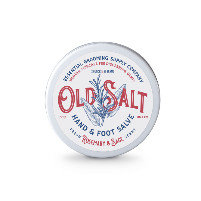 A round metal tin of Old Salt Hand and Foot Salve with a rosemary and sage scent; natural ingredients; white label features blue and red text plus a central rosemary sprig design.