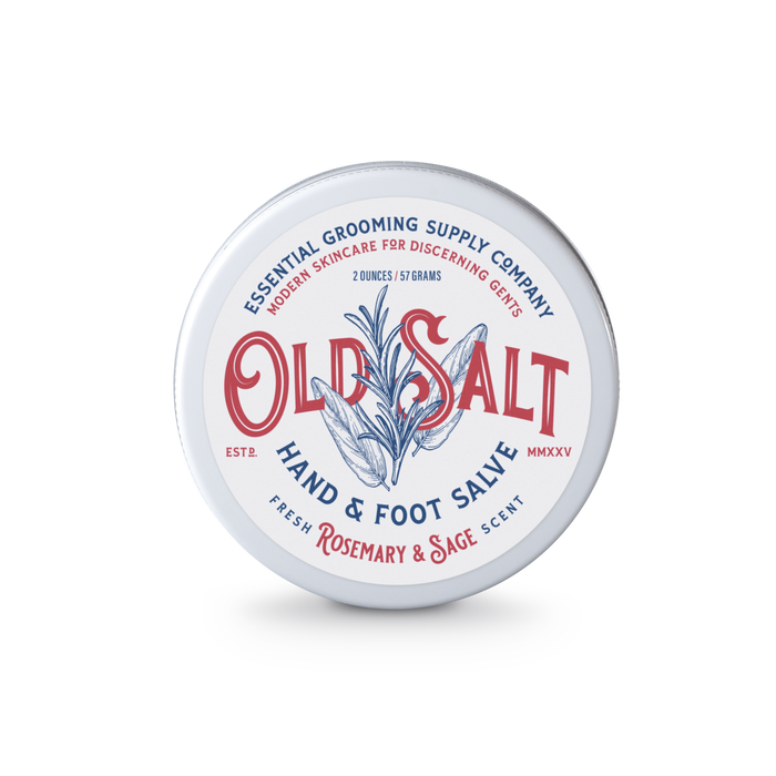A round metal tin of Old Salt Hand and Foot Salve with a rosemary and sage scent; natural ingredients; white label features blue and red text plus a central rosemary sprig design.