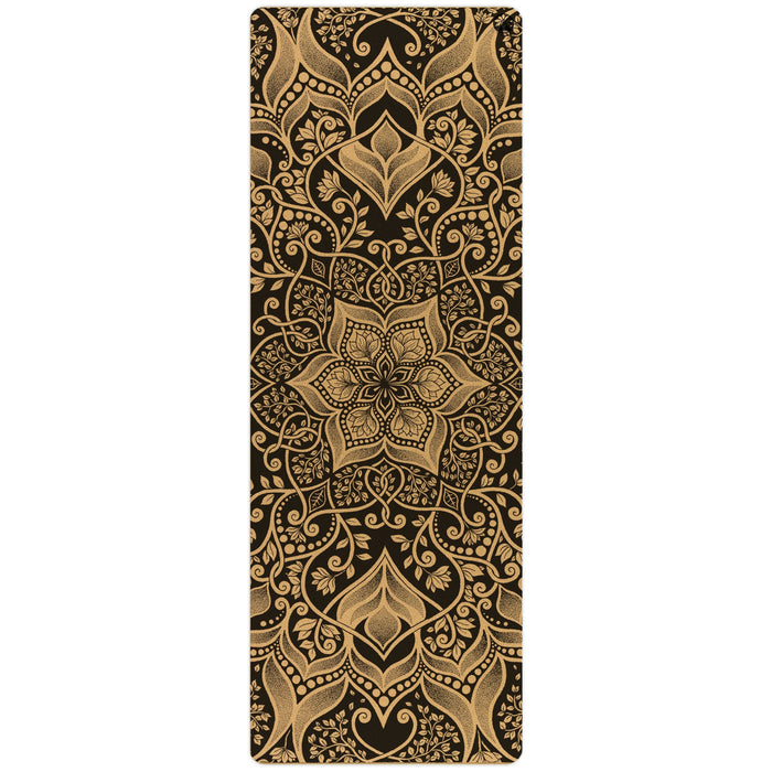The Harmony Aura Cork Yoga Mat by Yoloha Yoga is a cushioned yoga mat featuring an ornate gold mandala and floral pattern on a black background, showcasing intricate, symmetrical designs and detailed eco-friendly plant foam construction.