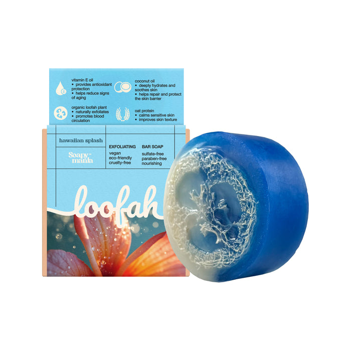 Soapymania’s Hawaiian Splash Exfoliating Loofah Bar Soap is shown beside its box, which displays product details and a flower with water droplets. This vegan soap gently exfoliates for refreshed, radiant skin.