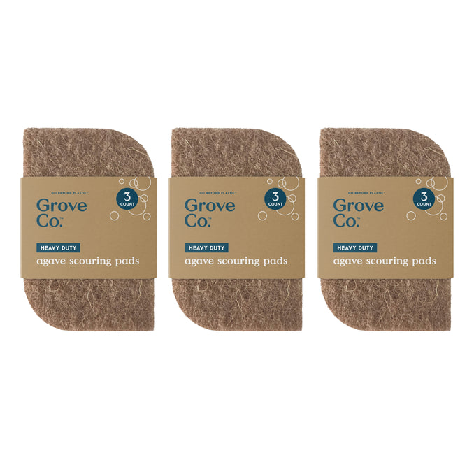 Three Grove Co. Heavy-Duty Agave Scouring Pads 3-Packs are side by side. Each pack has three brown, rectangular natural scrubbing pads with rounded corners, labeled heavy duty and plastic-free.