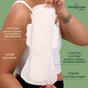 A person holds a large Hempress Hygienics Hemp Overnight Pad against their arm, with labels highlighting features: toxin-free, chlorine & fragrance-free, super absorption, leak-free, extra-long design, double wings—ideal for overnight use—and made from organic cotton and hemp. The Hempress Hygienics logo is visible.