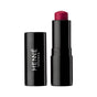 A black lipstick tube labeled Henne Organics Luxury Lip Tint stands next to its matching cap, displaying a rich, deep red hydrating lip color against a white background.