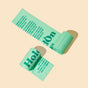 Two rolls of HoldOn Bags Compostable Small Space Bags, 4 gal - Unscented, with printed text are shown on a beige background. These BPA-free bags are ideal for eco-friendly waste disposal.
