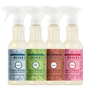 Four spray bottles of Mrs. Meyer’s Holiday Multi-Surface Cleaner Collection in holiday scents: blue Snowdrop, green Iowa Pine, brown Gingerbread, and red Peppermint, each featuring a garden-inspired scent.