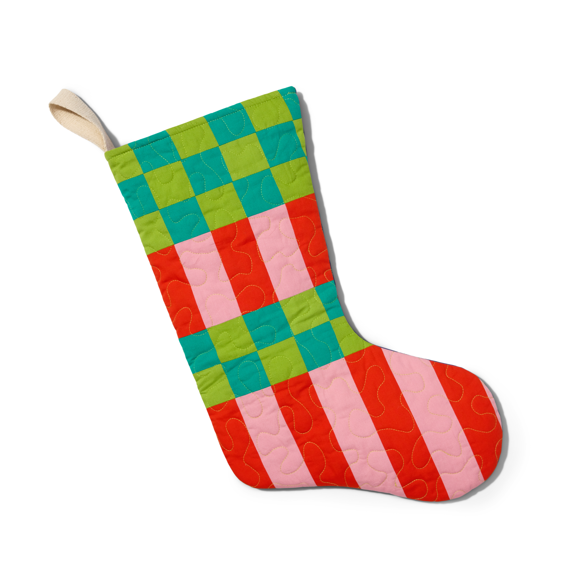 A Christmas stocking with a patchwork design in green, blue, red, and pink squares, featuring a beige hanging loop at the top.