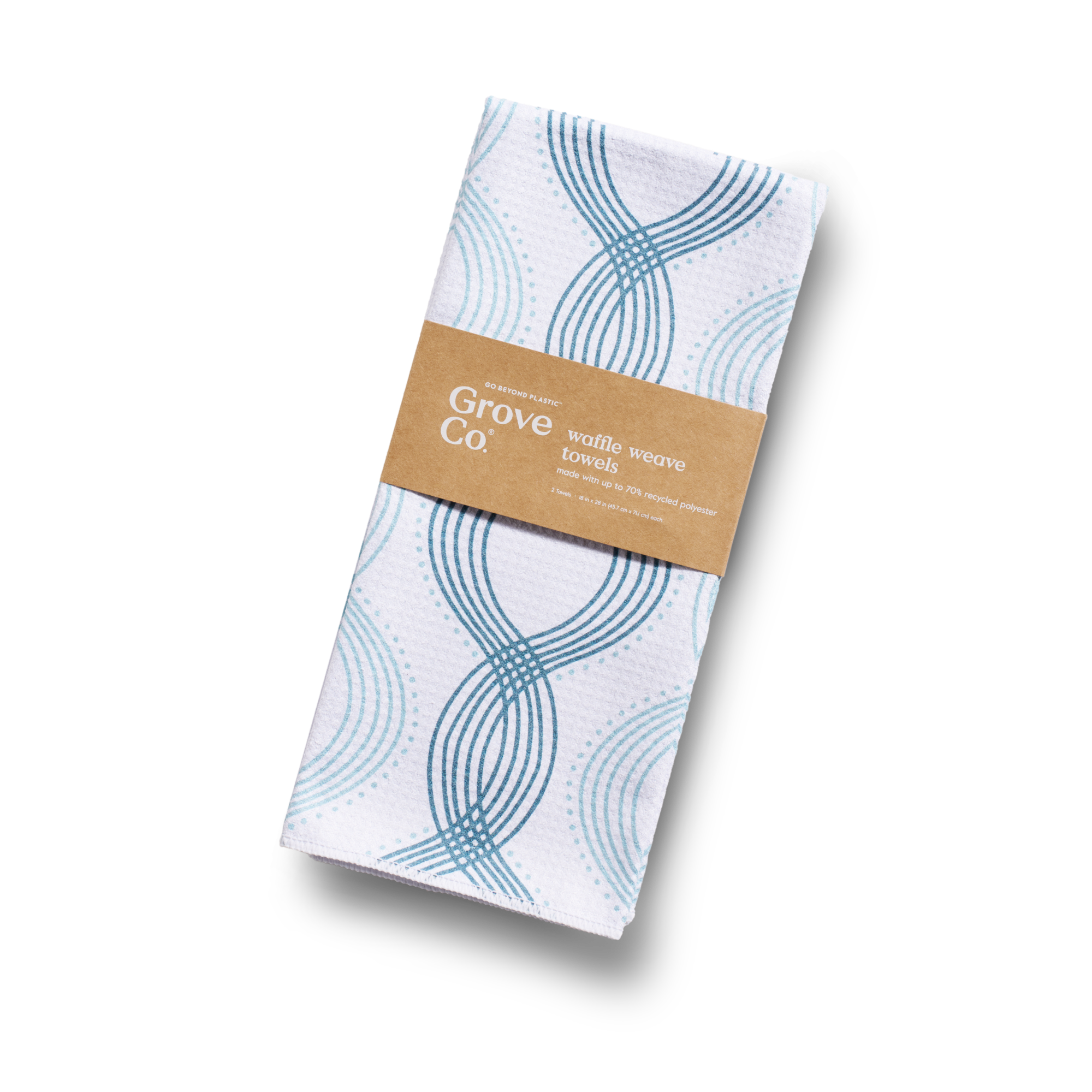 A folded white waffle weave towel with blue circular and curved line patterns, wrapped in a brown paper label that reads Grove Co. waffle weave towels. The background is plain white.