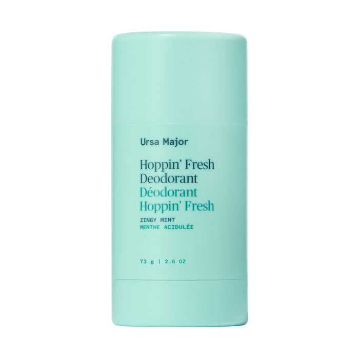 A turquoise stick of Ursa Major Hoppin Fresh Deodorant stands upright against a plain white background, with its aluminum-free formula and essential oils featured on the front label.