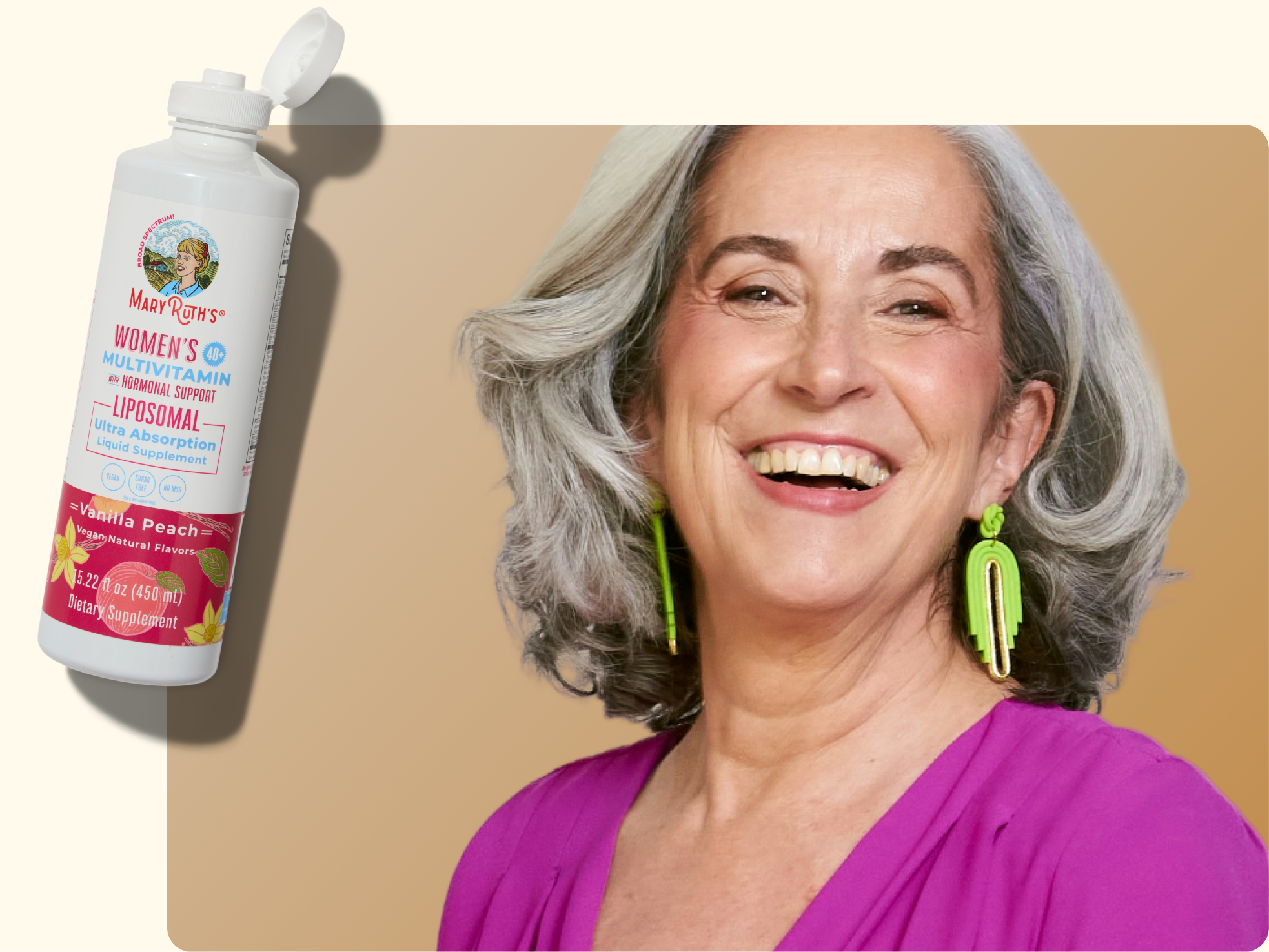 A smiling older woman with gray hair and bright green earrings wears a purple top. Next to her is a bottle of MaryRuth’s Women’s Multivitamin Liposomal supplement in vanilla peach flavor.