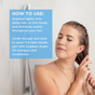 A woman is in the shower using both hands to apply Soapbox Argan Anti-Frizz Smoothing Serum to her wet hair. Text box reads: HOW TO USE: Disperse lightly onto damp hair...pair with Soapbox Argan Oil shampoo and conditioner for frizz-fighting results.