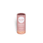 A pink cylindrical tube of Humble Brands Lip Balm - Paperboard stands upright on a white background, featuring a white label with a wave design and details including the use of organic coconut oil for moisturizing care.