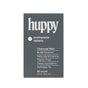 A dark gray Huppy Toothpaste Tablets with Tin in Charcoal Mint, featuring N-HA for cavity protection, natural whitening, clean ingredients, refillable tin, plastic-free packaging, and 62 tablets for a sustainable brushing routine.
