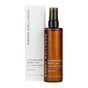 A brown Ember Wellness Hydrating Body Oil bottle with a black pump sits before its white box, both labeled “Sheer Santal” and “Mild Hydratant Corporel,” 3.4 fl oz/100 ml—formulated with sandalwood for a luxurious massage experience.