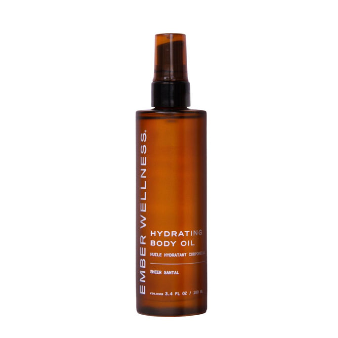 A brown bottle of Ember Wellness Hydrating Body Oil with a pump dispenser and white text. The label features Sheer Santal scent and a 3.4 fl oz (100 ml) volume. Ideal for nourishing massages.