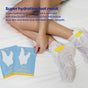 A person sits on a bed wearing the FaceTory Silky Feet Softening Foot Mask. Two blue and yellow mask packages are nearby. Text highlights deep hydration with shea butter and jojoba oil for nourished, revitalized feet.