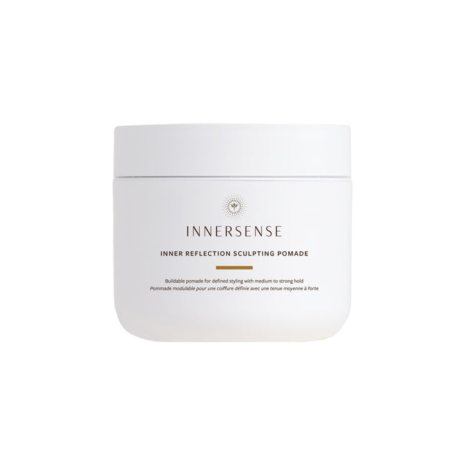 A white jar of Innersense Organic Beauty Inner Reflection Sculpting Pomade with minimalist branding sits against a plain background, ideal for curl definition and frizz control.