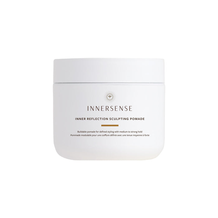 A white jar of Innersense Organic Beauty Inner Reflection Sculpting Pomade with minimalist branding sits against a plain background, ideal for curl definition and frizz control.