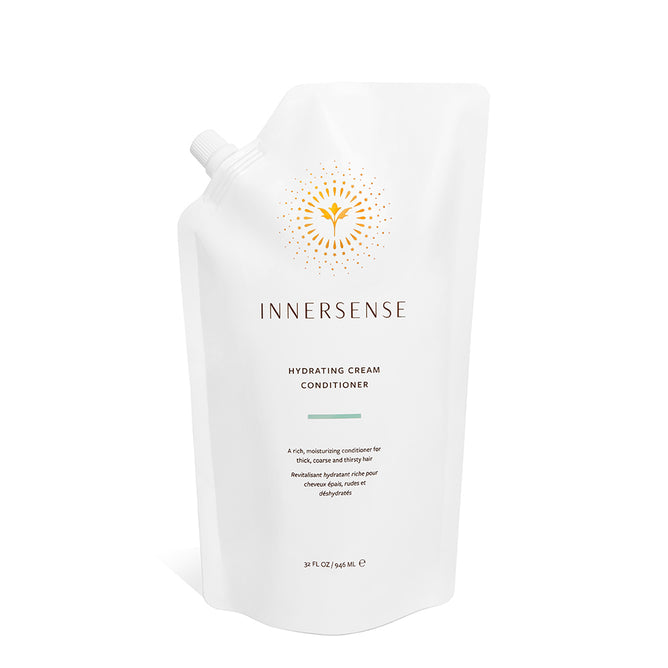 A white pouch of Innersense Organic Beauty Hydrating Cream Conditioner features a yellow sunburst logo, spout top, and gray and gold text—an ideal choice for natural, healthy hair care.