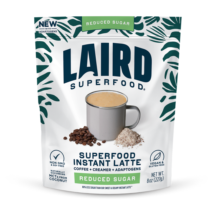 A package of Laird Superfood Reduced Sugar Instant Latte featuring a mug of latte, coffee beans, and powder on the packaging. Highlights include vegan, non-GMO ingredients, adaptogens, MCTs from coconut, and functional mushrooms.