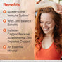 A smiling woman in an orange top raises her arm. Text highlights Jarrow’s Zinc Balance 15mg Veggie Caps—an essential mineral zinc supplement with copper that supports immune health.