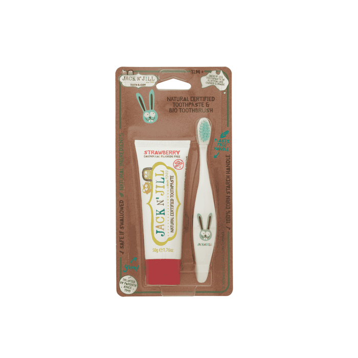 The Jack N Jill Tooth Buddy Pack includes a fluoride-free strawberry kids toothpaste and a white bio toothbrush with a cute bunny design, all in eco-friendly packaging on brown cardboard backing.