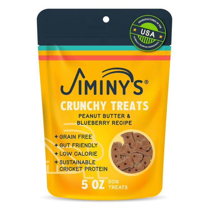 A yellow and orange pouch labeled Jiminy's Crunchy Peanut Butter & Blueberry Cricket Dog Treat, featuring grain-free, gut-friendly, low-calorie, sustainable dog treats made in the USA; 5 oz.