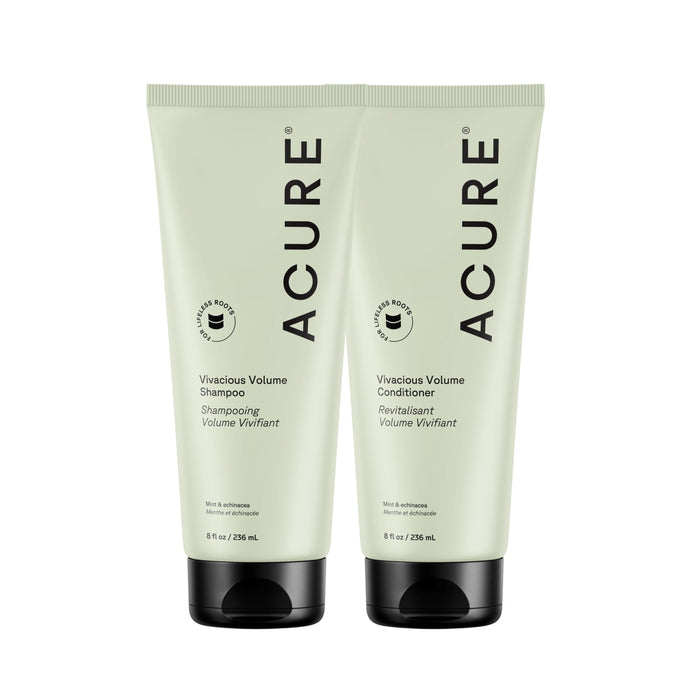 Two light green 8 fl oz tubes of the Acure Vivacious Volume Shampoo and Conditioner Set stand side by side with black caps, featuring bold black text and infused with moringa and mint.