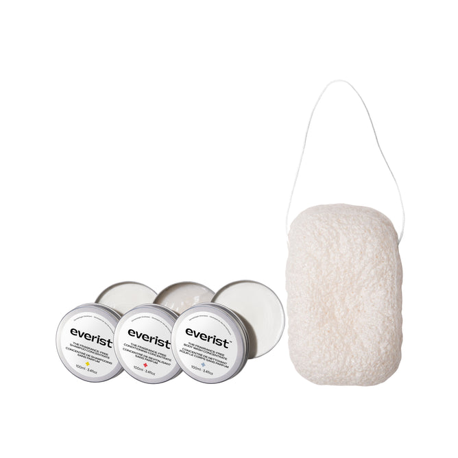 Three small Everist tins from The Fragrance-Free Hair & Body Care Bundle sit beside a white konjac sponge with loop handle, all set against a plain white background.