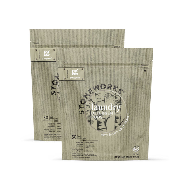 Two beige pouches of grab green Stoneworks Laundry Detergent Pods in Birch Branch scent. Each eco-friendly pouch contains 50 odor-neutralizing pods with minimalist design and nature-inspired fragrance.