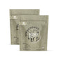 Two beige pouches of grab green Stoneworks Laundry Detergent Pods in Birch Branch scent. Each eco-friendly pouch contains 50 odor-neutralizing pods with minimalist design and nature-inspired fragrance.