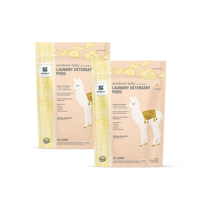Two pastel packages of grab green Newborn Laundry Detergent Pods - Chamomile, each with a white llama illustration, golden saddle, yellow clouds, and product info. Perfect for cloth diapers—30 loads per pack.