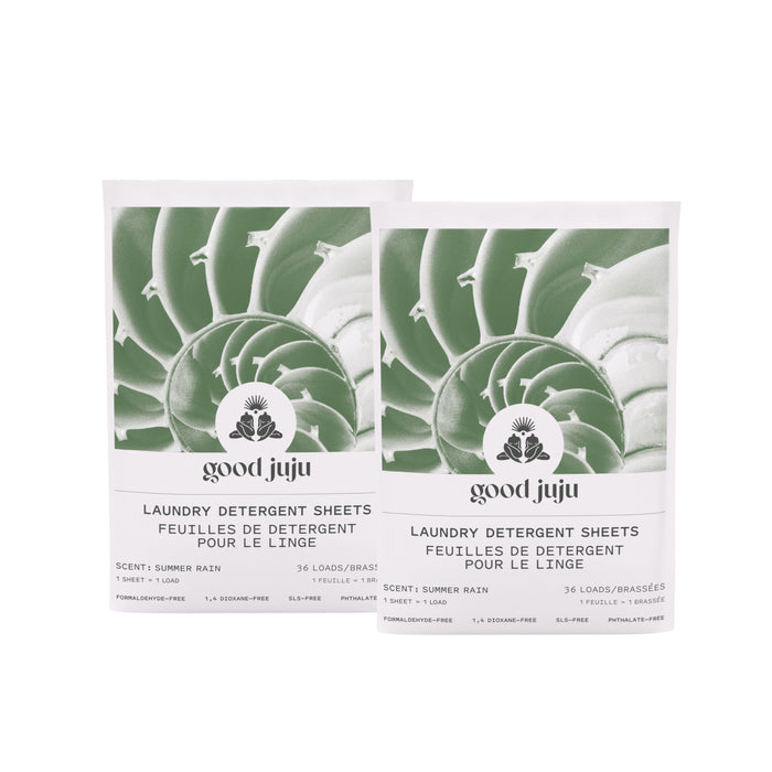 Two identical pouches of Good Juju Body & Home Laundry Detergent Sheets, Summer Rain, each featuring a green spiral graphic and text in English and French indicating 36 loads.