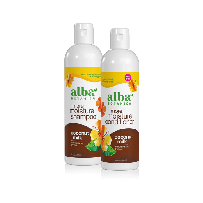 Two bottles of Alba Botanica's Shampoo & Conditioner Set – More Moisture Coconut Milk for dry hair, with vibrant hibiscus flower designs and green-yellow labels.