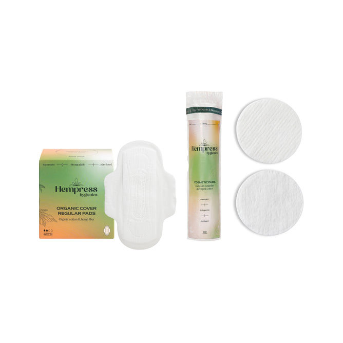 A box of Hempress Hygienics Hemp Regular Pads and free Hemp Cosmetic Rounds are displayed on a white background. Embrace sustainable self-care with the Buy Hemp Regular Pads, Get Hemp Cosmetic Rounds Free offer.